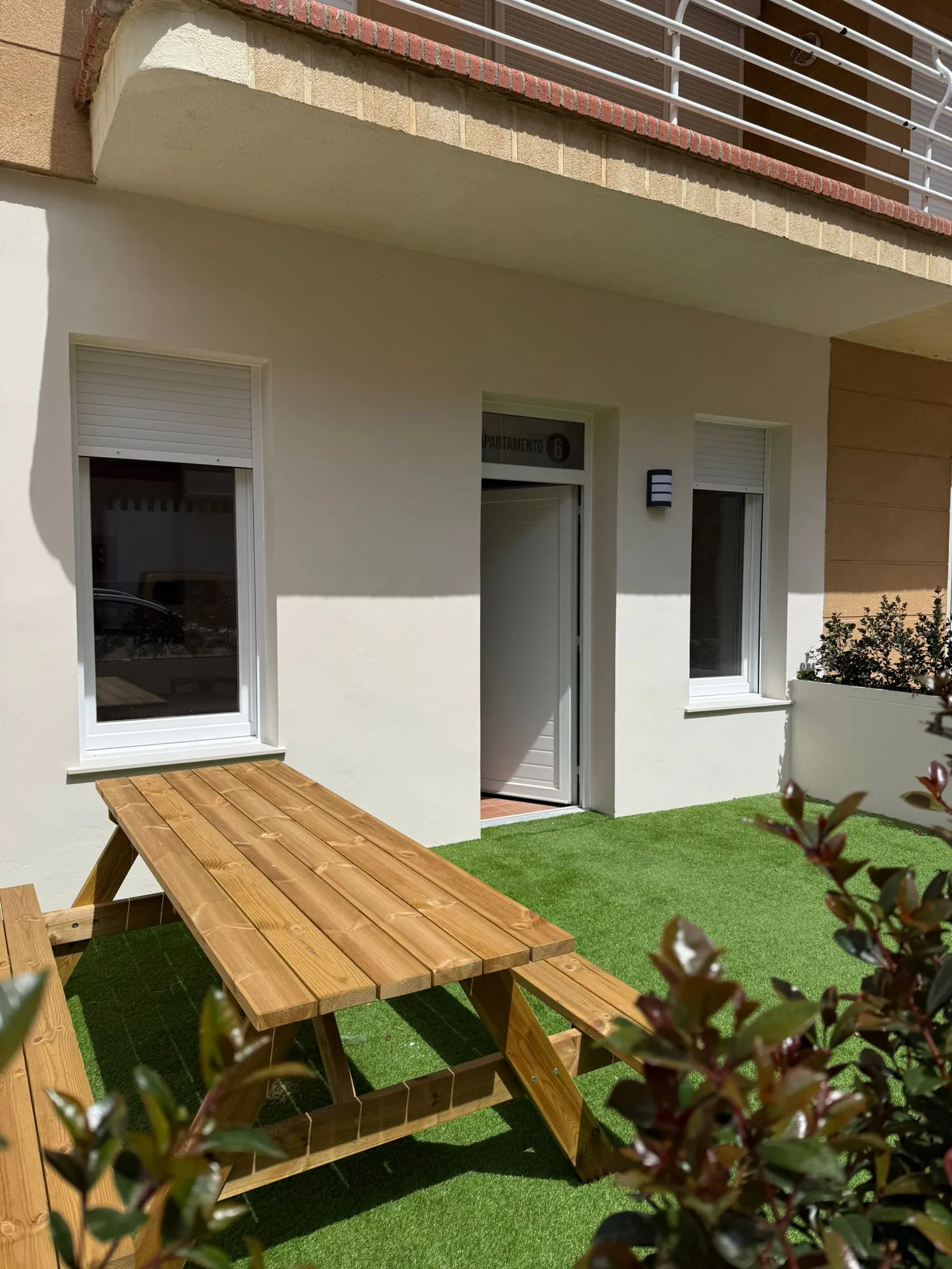 Private terrace with lawn and wooden picnic table